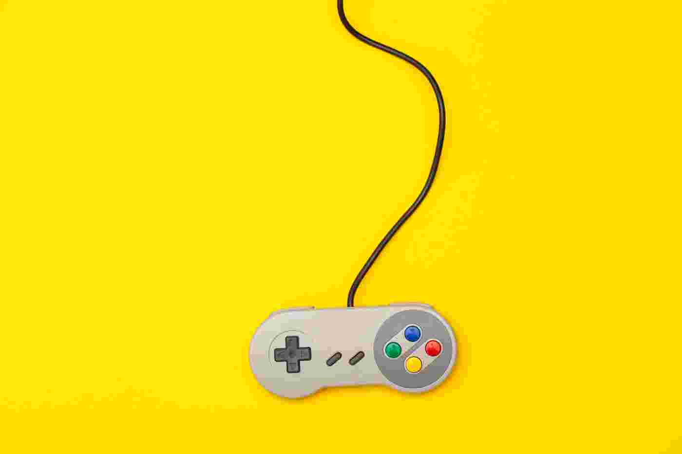 Video Game Retro Computer Gaming Controller On A Yellow Backg R46PWA7